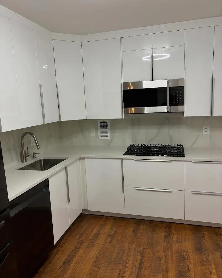 Restored kitchen with white cabinets after water damage in Marlboro Village
